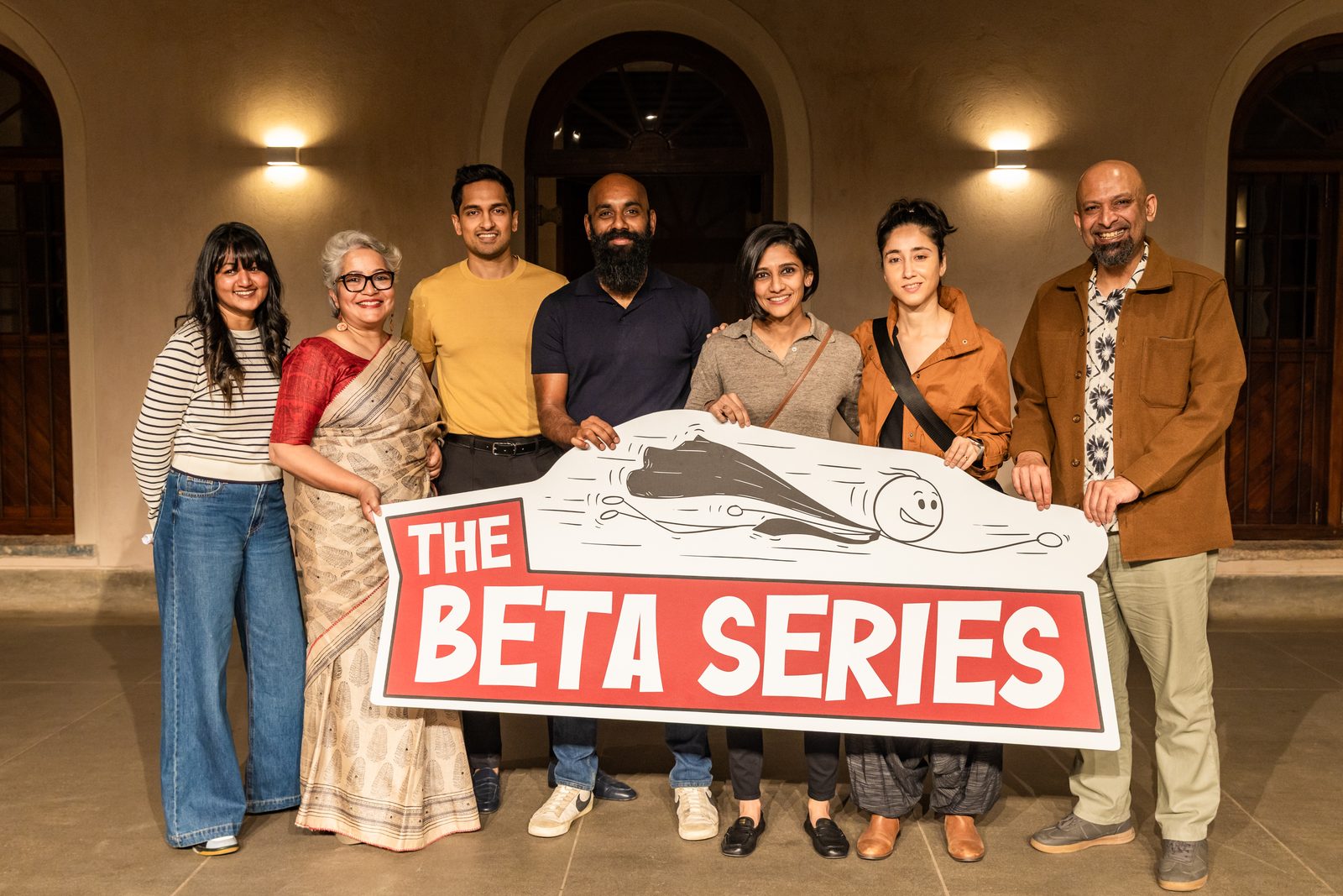 Speakers and organisers with The Beta Series sign.